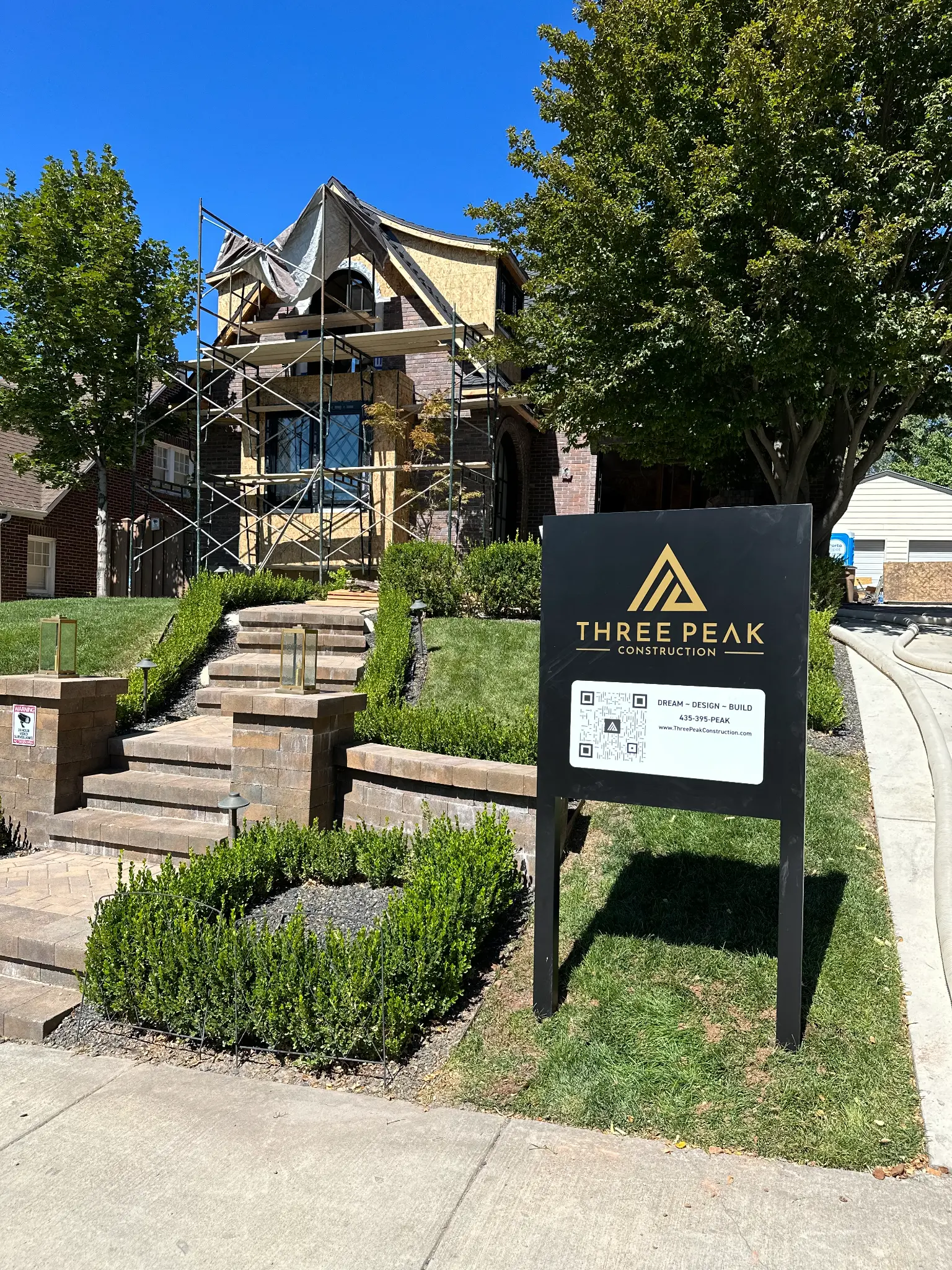 Three Peak Construction job site with branded sign