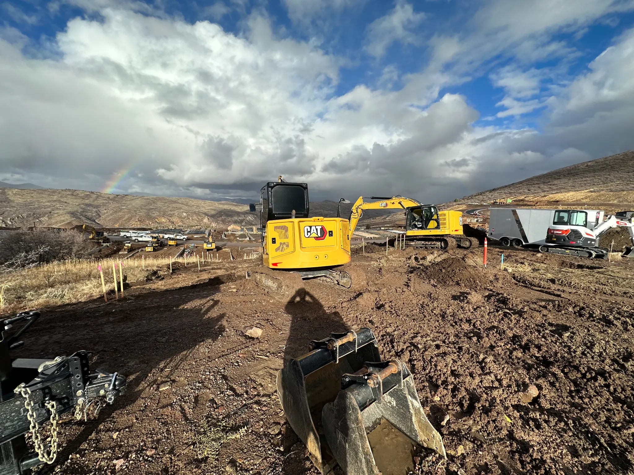 Excavation work in the Wasatch Back with rainbow