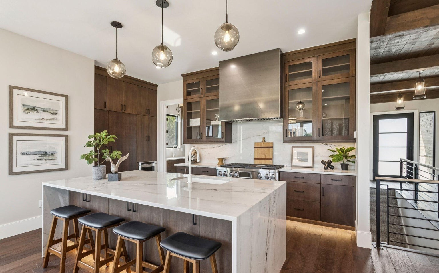 Kitchen alternate angle showing marble island and glass-front cabinets