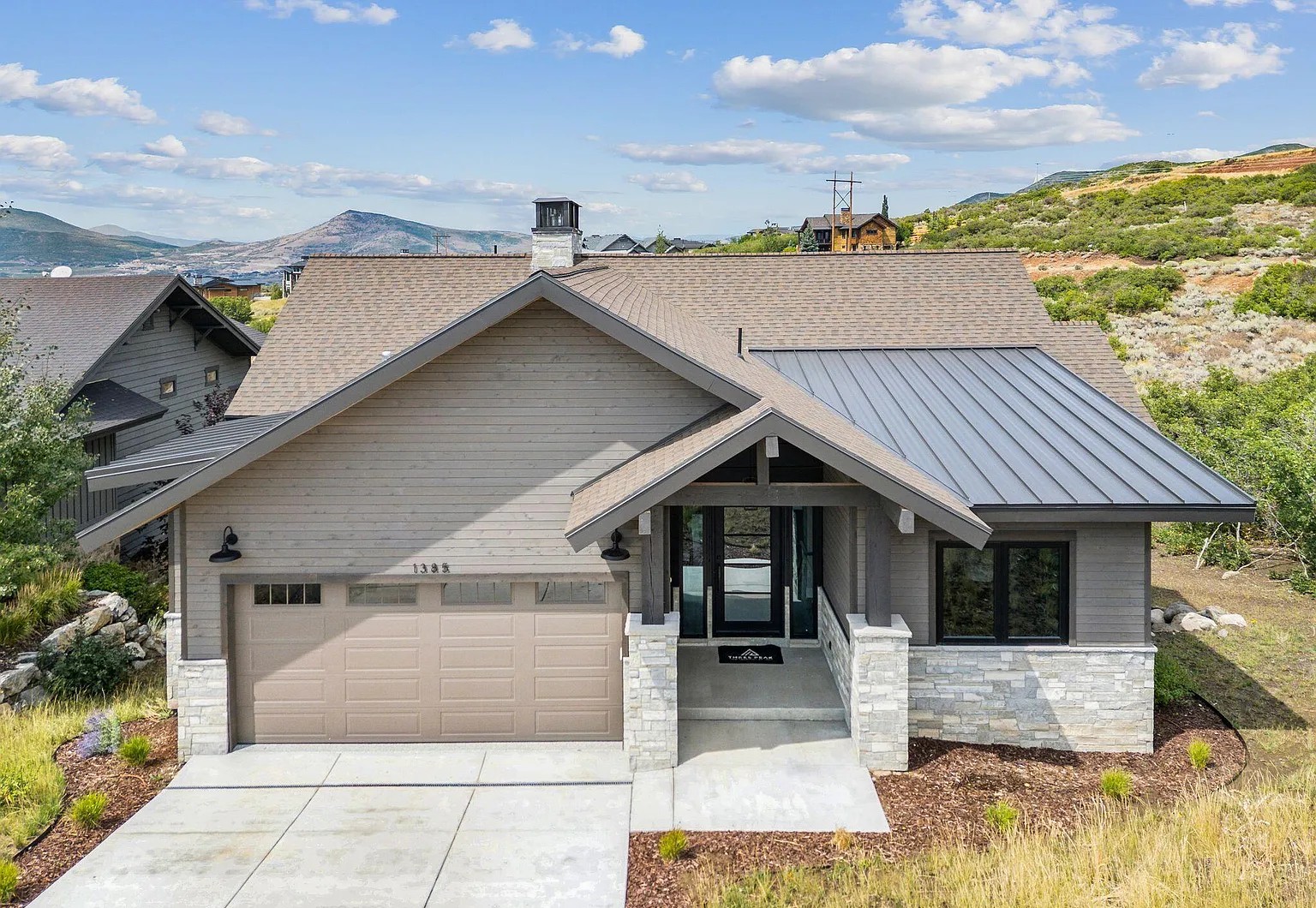 Completed $2.945M Park City Parade of Homes custom home — mountain modern exterior with stone, wood, and metal