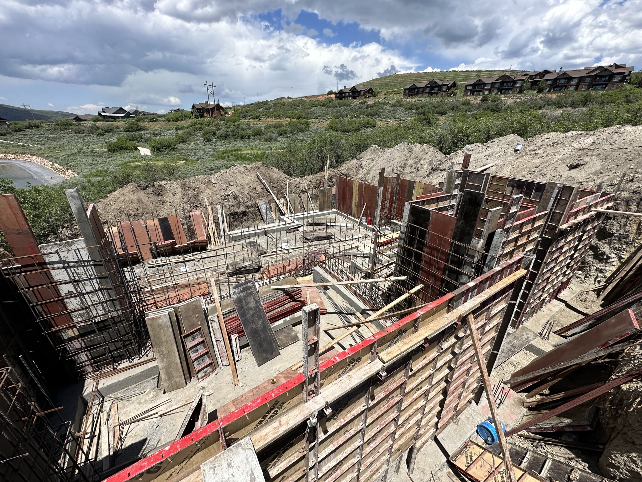 Concrete foundation formwork with rebar grid — engineered foundation system for mountain terrain