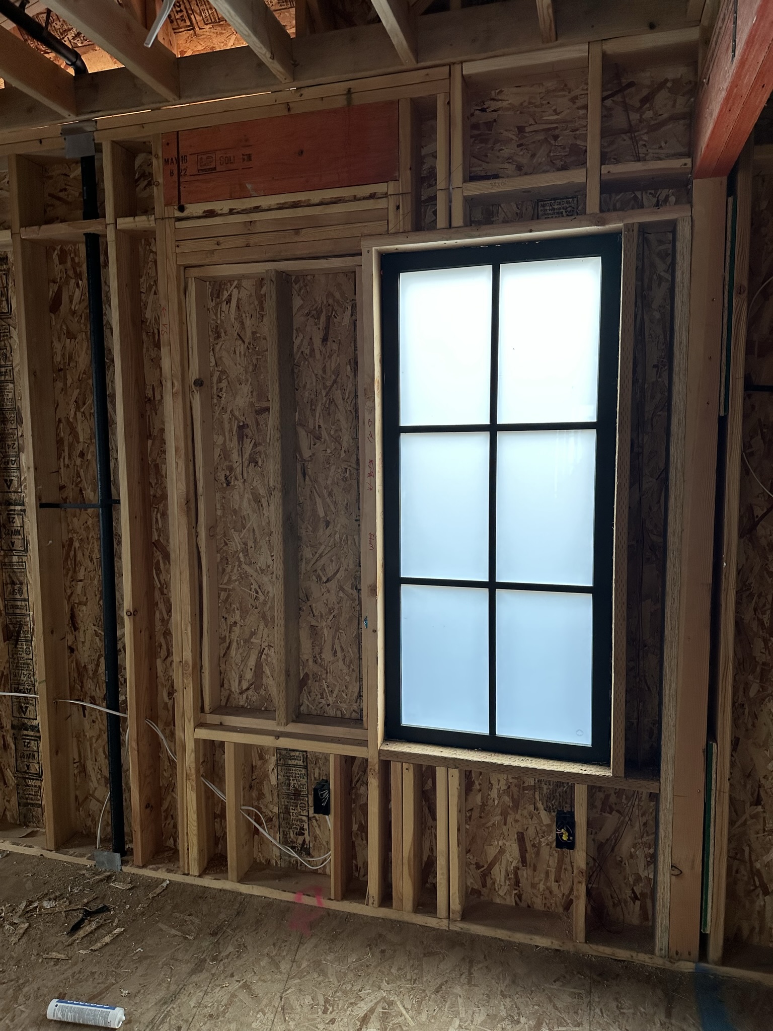 Structural connection detail showing new framing bolted to existing masonry with engineered hardware