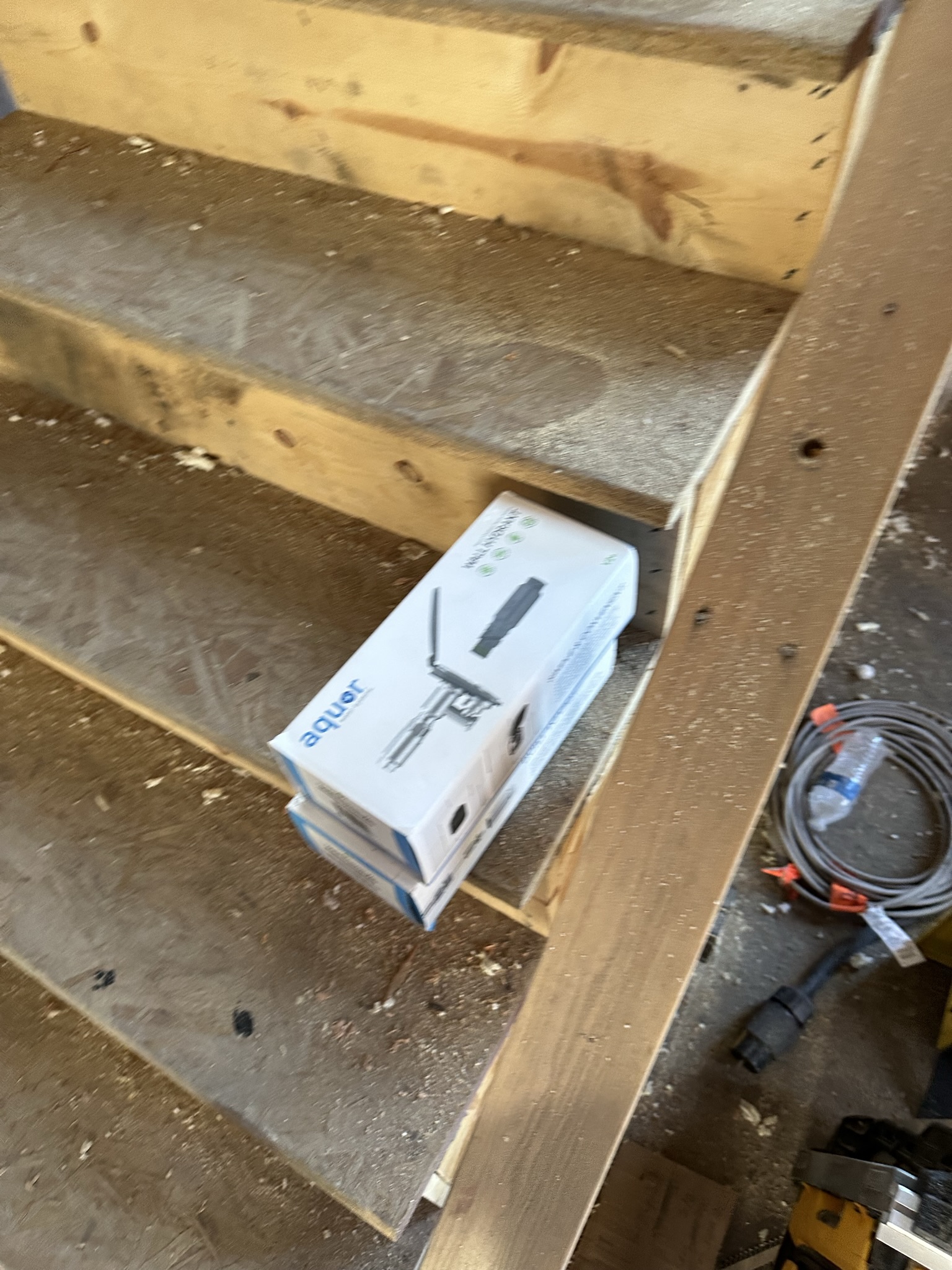 New staircase construction with solid stringers and OSB treads — connecting original main level to new second story addition