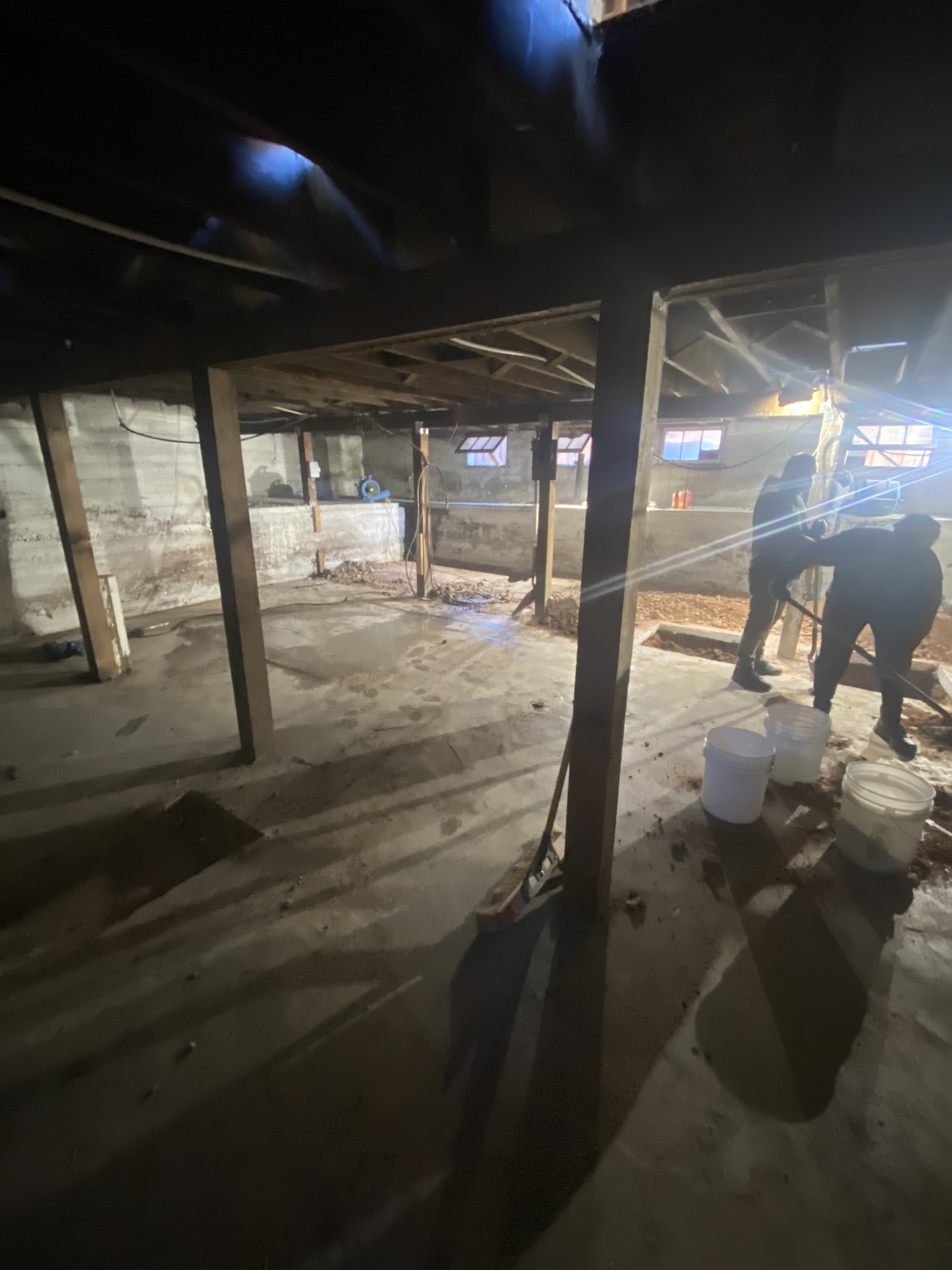 Crew members working in the basement during structural steel installation