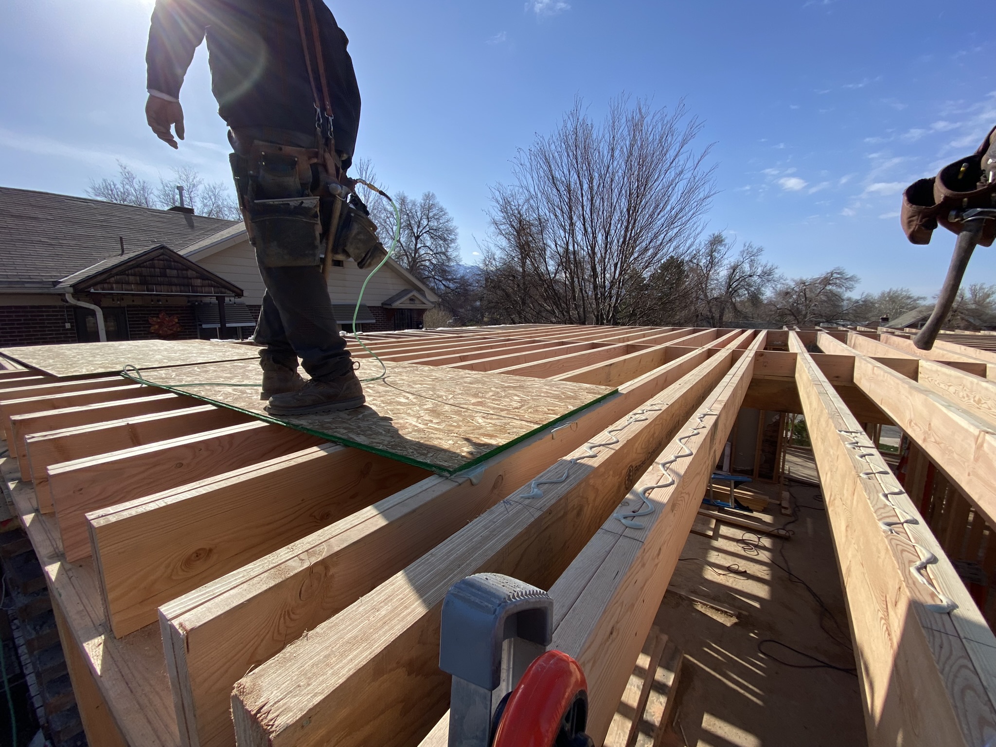 New engineered floor joist system installed on steel beams and new concrete foundation walls