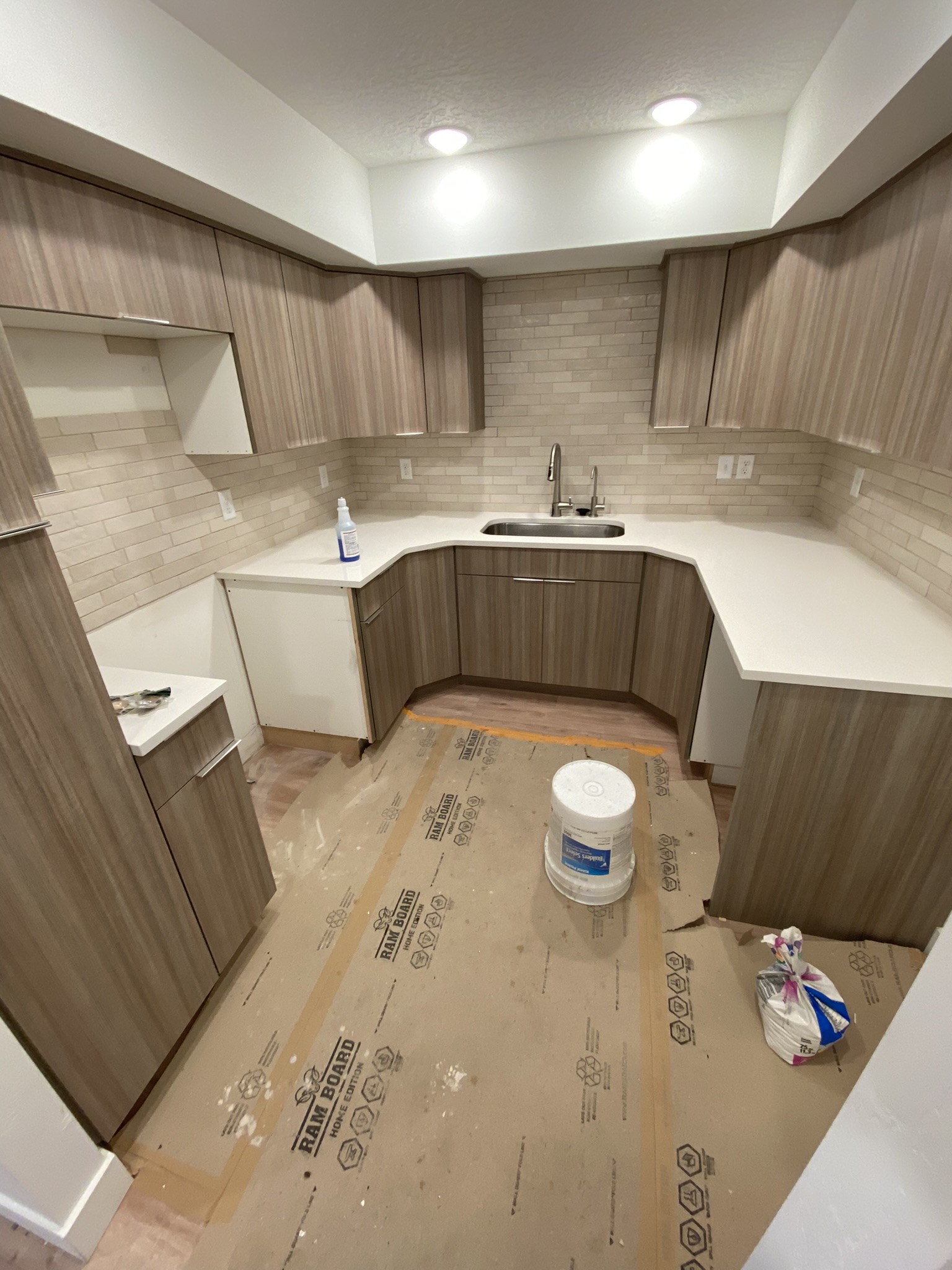 Kitchen with counters and backsplash installed