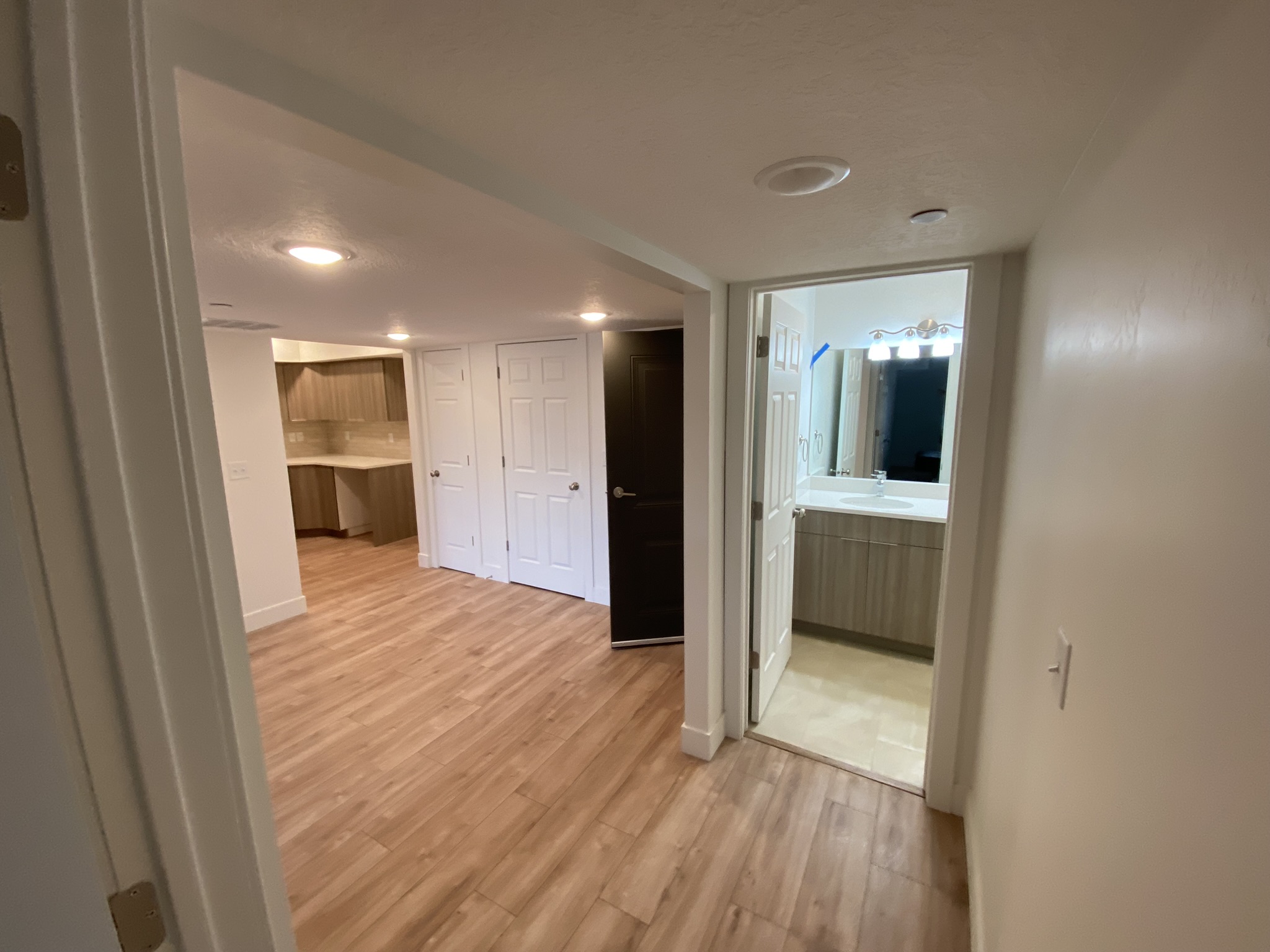 Hallway showing open floor plan and kitchen in background