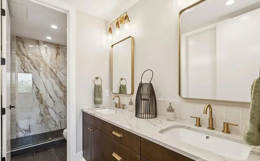 Master bathroom with marble counters and gold fixtures