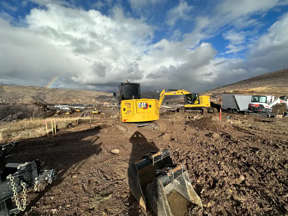 Excavation work in the Wasatch Back with rainbow