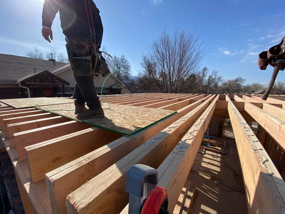 New engineered floor joist system installed on steel beams and new concrete foundation walls
