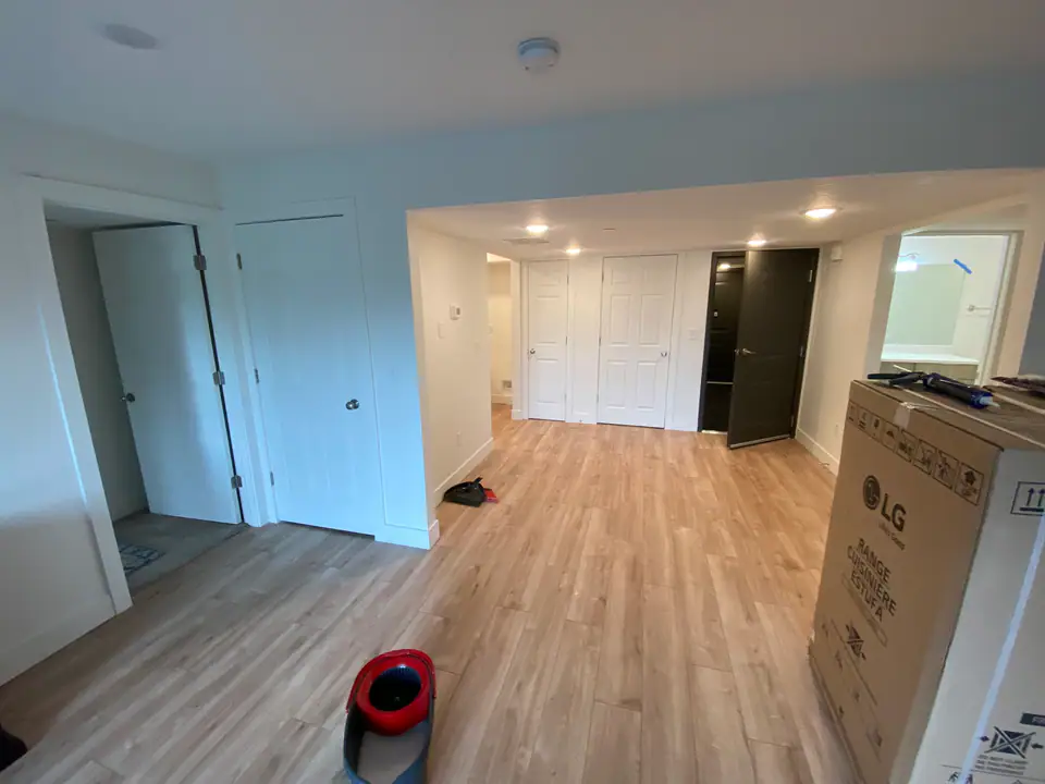 Wide view of living area showing full renovation scope