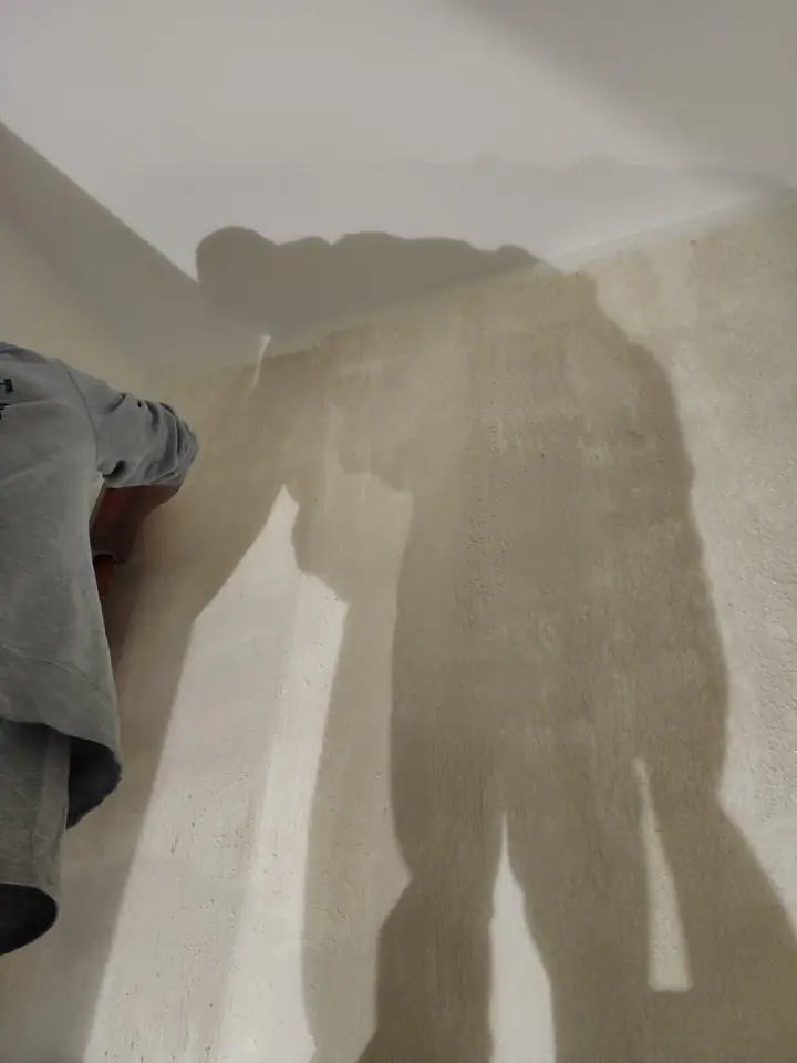 Venetian plaster being applied to powder room wall — multiple layers creating depth and texture