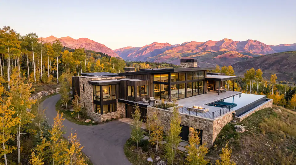 Aerial view of completed custom home among fall aspens in the Wasatch Back